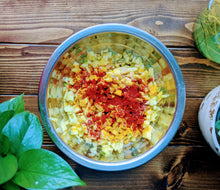 Load image into Gallery viewer, SpiceFix Kashmiri chili powder being used as part of a spice rub for vegetables