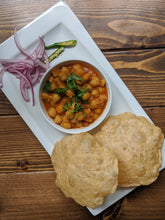 Load image into Gallery viewer, Indian Chole / Chana Bhatura ( Chickpea Curry ) with Bhatura ( puffed flat bread ) on a plate with pickled onions and green chilies 
