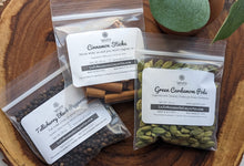 Load image into Gallery viewer, SpiceFIx Aromatic Wonder gift set spices on display. Whole green cardamom pods, whole cinnamon sticks, whole Tellicherry black peppercorns
